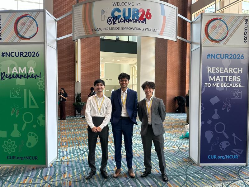 Team at the NCUR 2026 welcome arch — Anuranan with teammates
