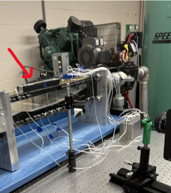 Wind tunnel test section showing pressure tap tubes connected to the nozzle floor